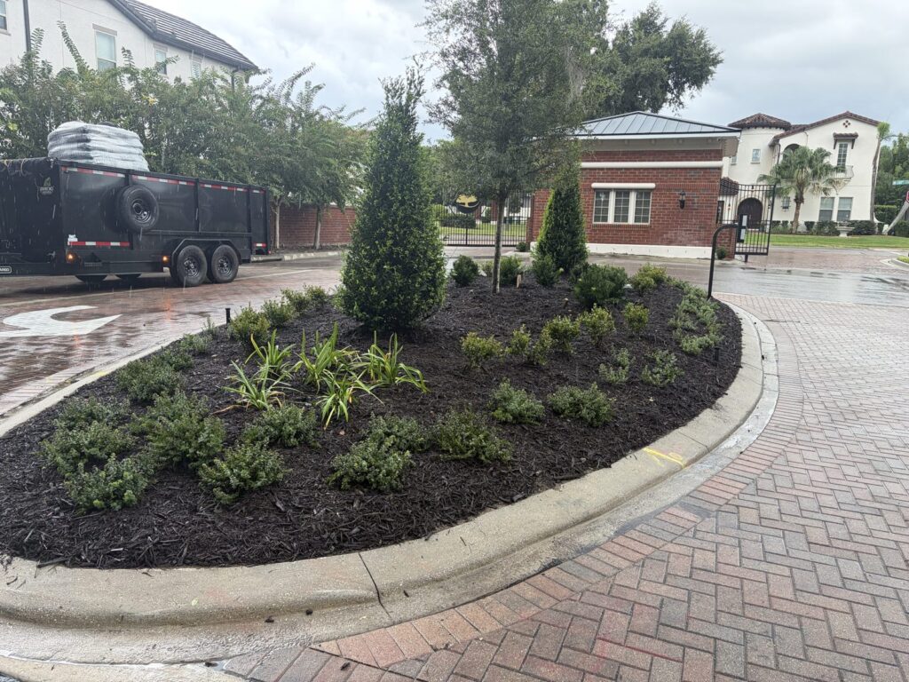 Canopy Oaks gated entrance island bed rebuilt by Oakcrest Outdoors